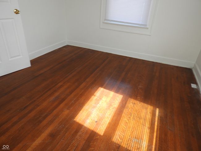 bedroom with hardwood floor and baseboards | Image 11