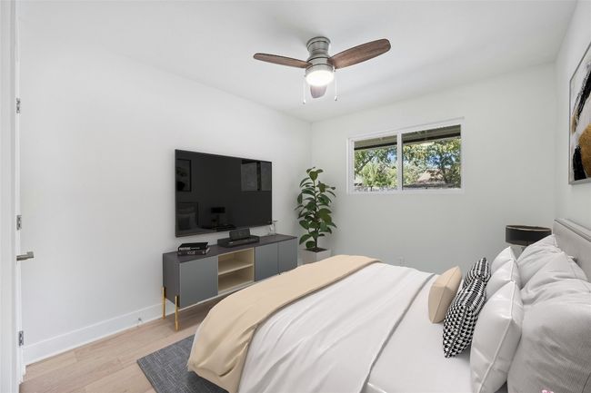 Bedroom with light wood-style flooring and ceiling fan | Image 26
