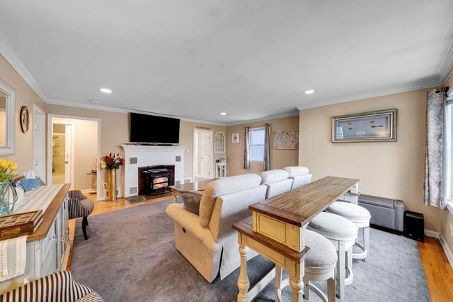 Living area featuring wood finished floors, recessed lighting, and ornamental molding | Image 28
