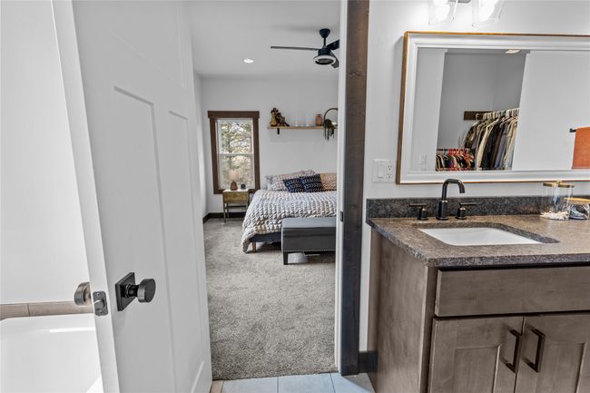 Bathroom with vanity, ensuite bath, a ceiling fan, a walk in closet, and tile patterned flooring | Image 30