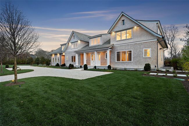 View of front of home with a yard, roof with shingles, curved driveway, and a porch | Image 48