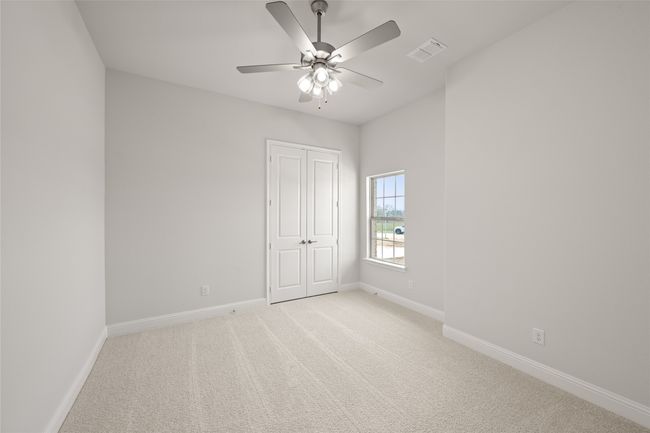 Unfurnished bedroom featuring light carpet, baseboards, a closet, and a ceiling fan | Image 22
