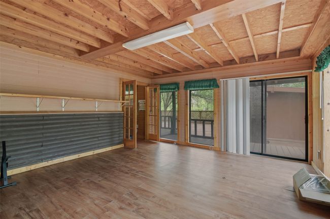 Another flex space off the primary bedroom to meet your needs with great views of the lush outdoor greenery and back patio. | Image 16