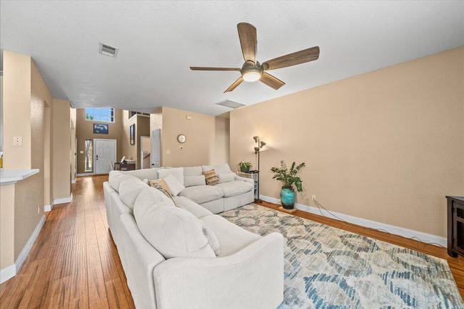 Living area featuring light wood finished floors, ceiling fan, and baseboards | Image 16