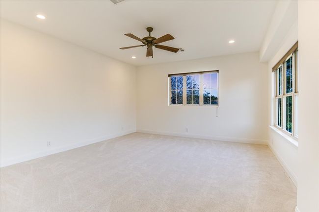 Oversized game room or family room upstairs, with ceiling fan, recessed lighting, and new carpet | Image 28