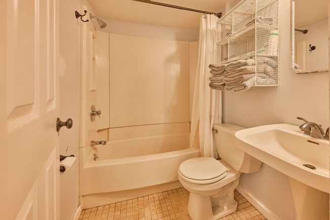 Bathroom featuring toilet, tile patterned flooring, and shower / tub combo | Image 9