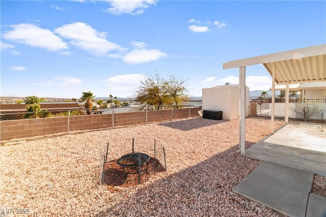 View of yard featuring a fenced backyard, a patio, and an outdoor structure | Image 33