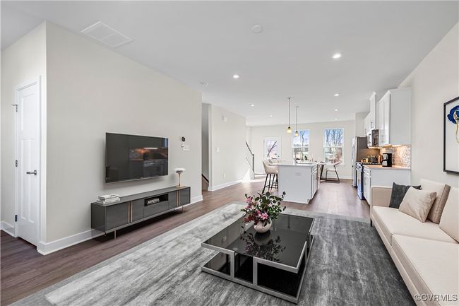 Living room with baseboards, visible vents, and wood finished floors | Image 8