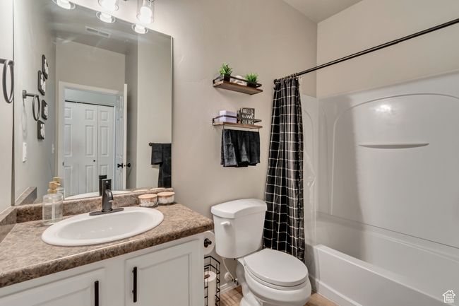 Bathroom with vanity, shower / bath combo, and toilet | Image 14