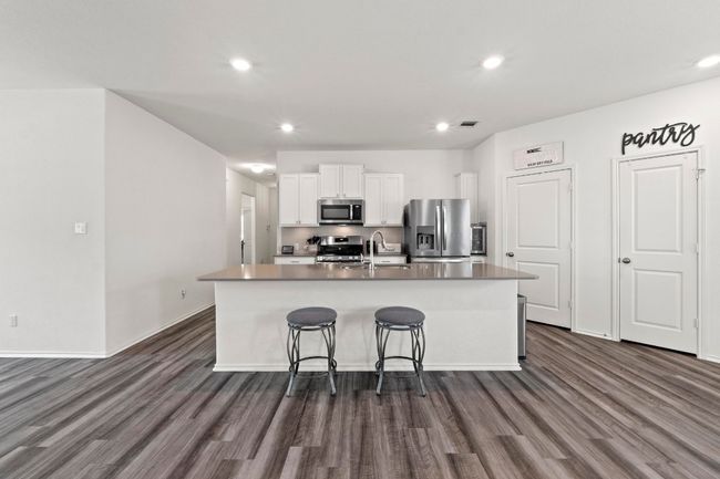 An oversized island with Silestone counter tops is the perfect place to gather. | Image 8