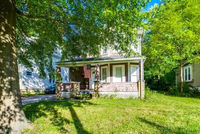 View of front of home with covered porch and a front yard | Image 2