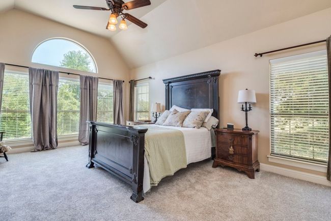 Primary bedroom with high ceilings and new carpet | Image 13