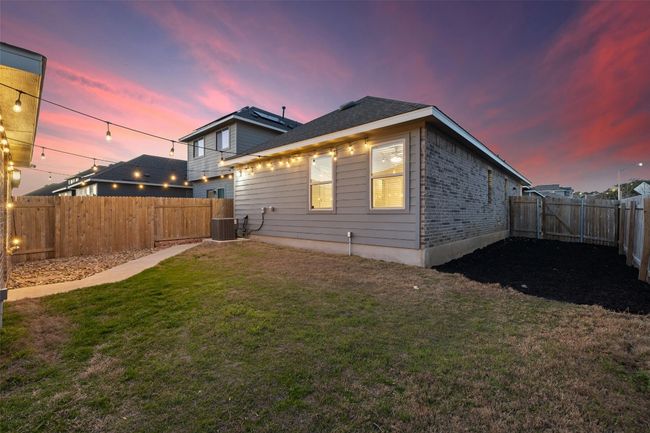 Rear view of house with a yard, central AC, and a fenced backyard | Image 25