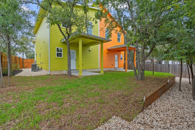 Back of house featuring a fenced backyard, a lawn, a patio area, and central AC | Image 25