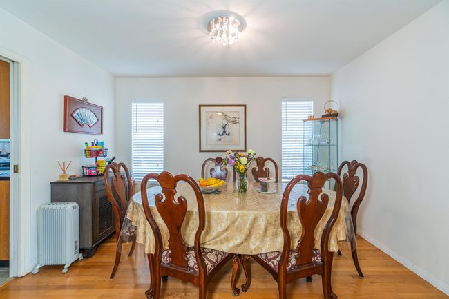 Dining room featuring light wood-type flooring, healthy amount of natural light, baseboards, and radiator heating unit | Image 9