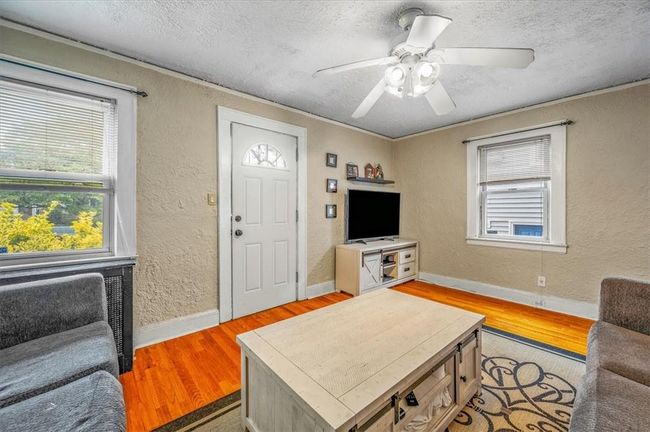 Living room with ceiling fan, light hardwood / wood-style flooring, and a textured ceiling | Image 26