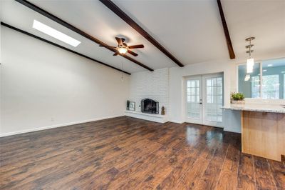 Unfurnished casual living room with view of French doors leading to sunroom | Image 2