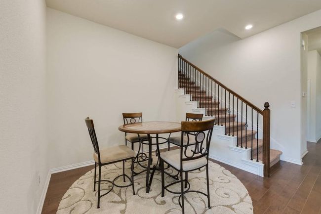 Dining room with wood finished floors, stairway, recessed lighting, and baseboards | Image 11