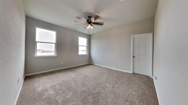 Spare room featuring carpet flooring, a ceiling fan, and baseboards | Image 4