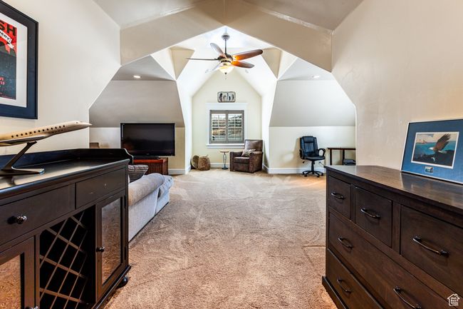 Bedroom with light carpet, baseboards, and vaulted ceiling | Image 21