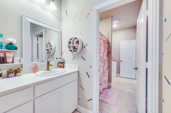 Bathroom featuring tile patterned flooring, baseboards, vanity, and visible vents | Image 21