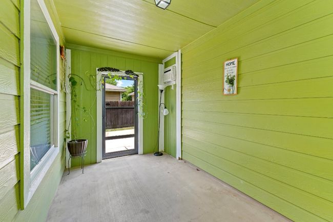 Unfurnished sunroom with a wall unit AC | Image 33