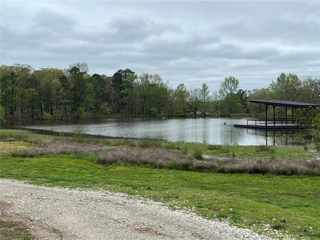 Property view of water with a forest view and a boat dock | Image 7