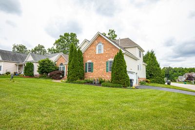 View of front property featuring a front lawn and a garage | Image 2