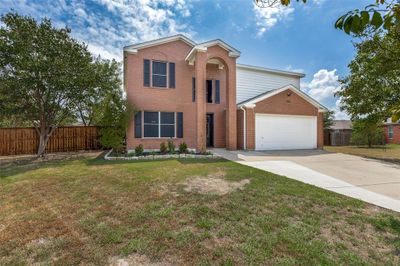 View of front of home with a garage and a front yard | Image 1