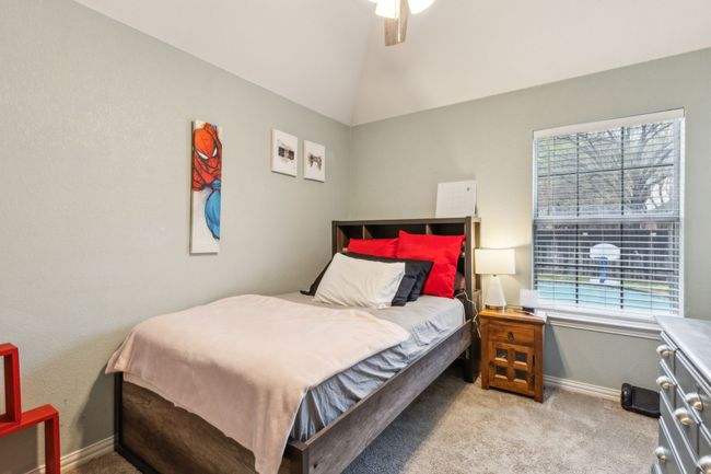 Bedroom featuring light carpet, baseboards, vaulted ceiling, and ceiling fan | Image 24
