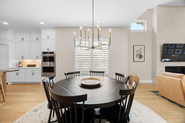 Dining room featuring light wood-style flooring, a chandelier, and recessed lighting | Image 10