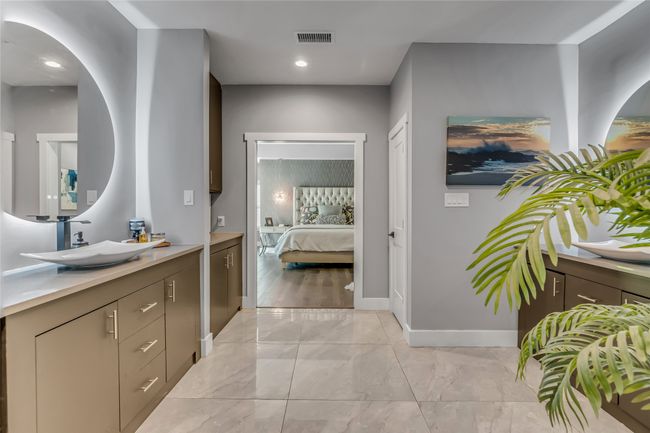 Ensuite bathroom featuring vanity, marble finish flooring, and recessed lighting | Image 24