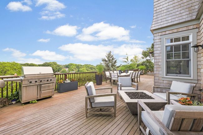 Large deck with Mianus River Valley views accessed from the kitchen, family room and outdoor covered room. | Image 25