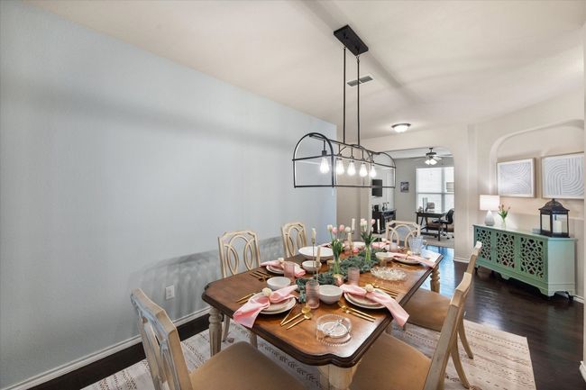 Dining area featuring ceiling fan, dark wood-style flooring, baseboards, and visible vents | Image 8