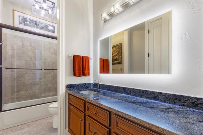 Full bathroom featuring enclosed tub / shower combo, toilet, and vanity | Image 22