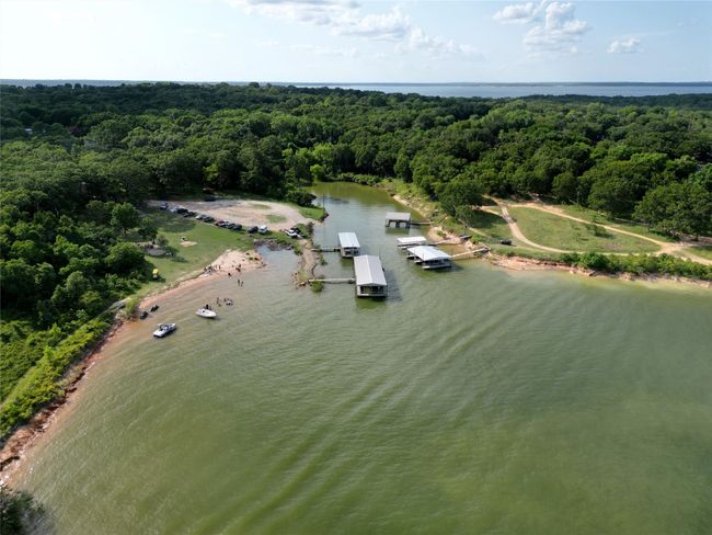 Aerial view of the nearby sandy shoreline to stroll, boat ramp, docks, and beach for your lake leisure. | Image 27