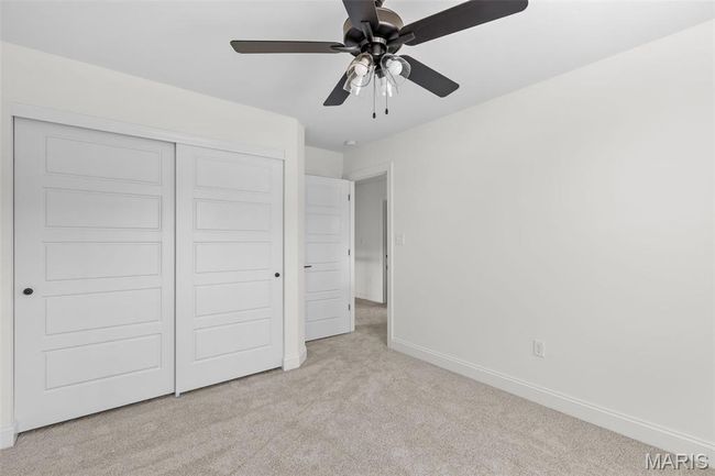 Unfurnished bedroom featuring carpet floors, a closet, and a ceiling fan | Image 9