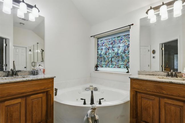 Bathroom with two vanities, a jetted tub, and vaulted ceiling | Image 19