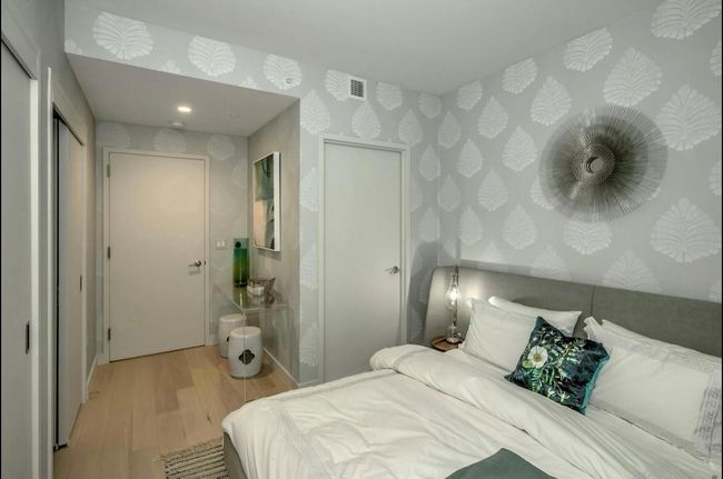 Bedroom featuring wallpapered walls and wood finished floors | Image 15