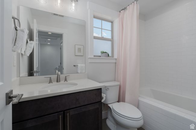 Full bathroom with vanity, toilet, and shower / tub combo | Image 35