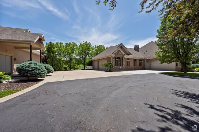 View of front of house featuring a garage, concrete driveway, and brick siding | Image 15