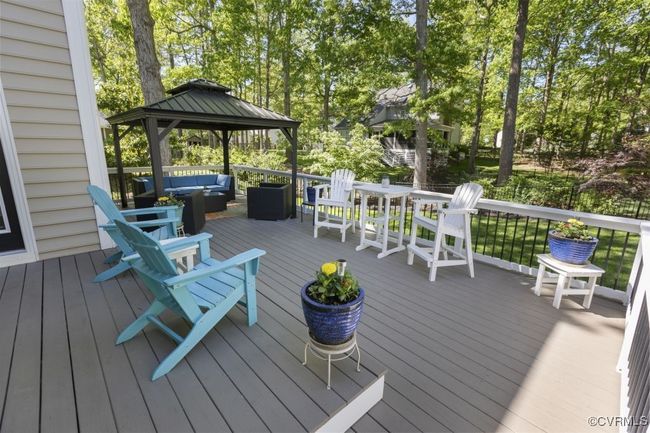 Wooden terrace with an outdoor living space, a gazebo, and view of scattered trees | Image 40