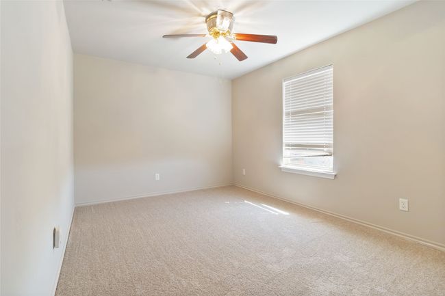 Carpeted spare room with baseboards and ceiling fan | Image 17