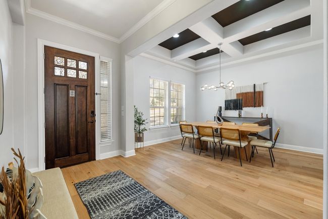 You'll be greeted by a bright open entry, high coffered ceilings and designer overhead dining room chandelier. A stylish color palette ties it all together. | Image 6