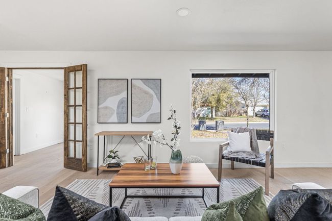 Living area featuring light wood-style floors and baseboards | Image 8