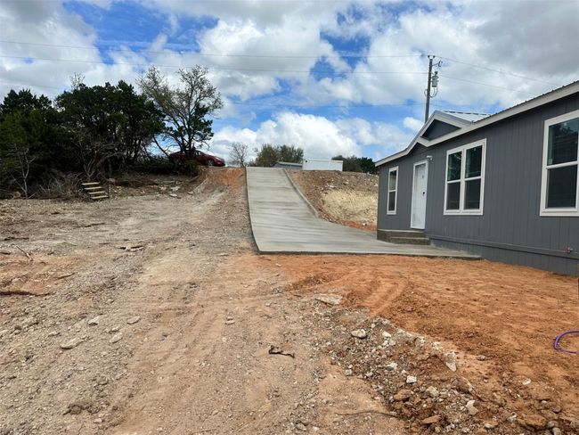 View of yard with entry steps | Image 12