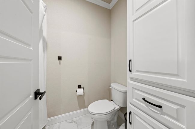 Bathroom featuring toilet, marble finish floor, and baseboards | Image 15