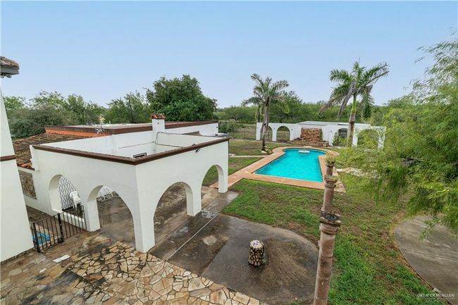 View of swimming pool with a patio | Image 27