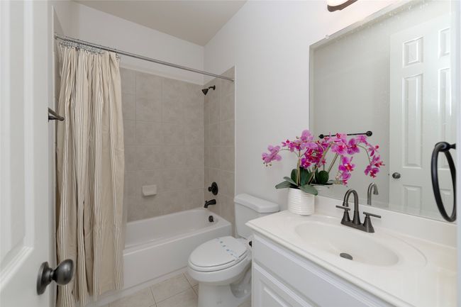 Bathroom featuring shower / bath combo, vanity, and tile patterned flooring | Image 24