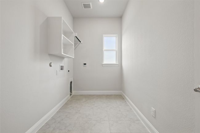 Laundry area with hookup for a washing machine, gas dryer hookup, visible vents, electric dryer hookup, and laundry area | Image 33